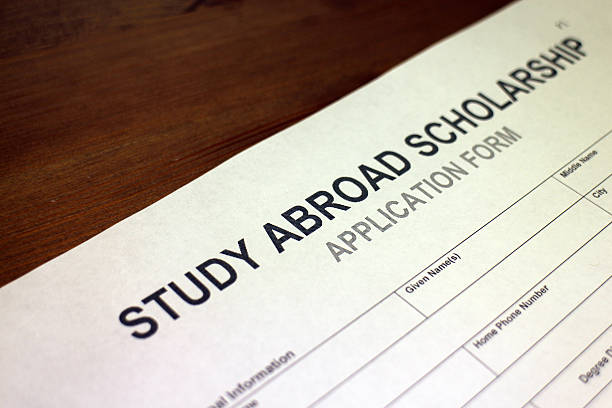 Someone filling out Study Abroad Scholarship Application Form.