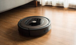 Robot vacuum cleaner on wood,laminate floor.Smart life concepts ideas