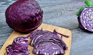 part of red cabbage on gray wooden table